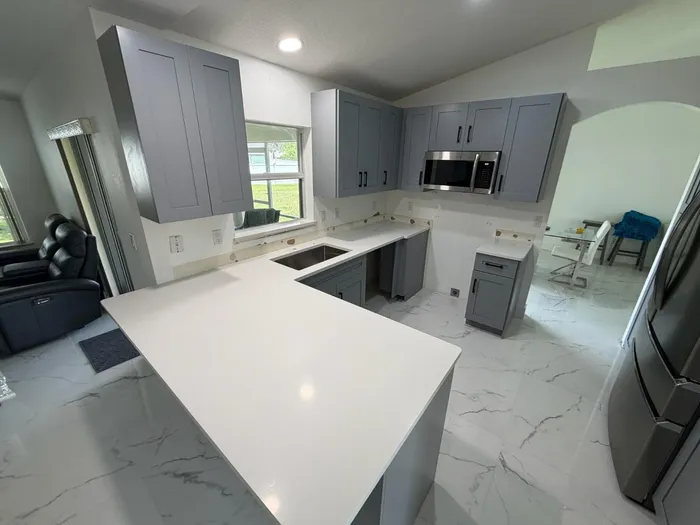 Kitchen remodel in progress with new gray cabinetry in a Houston home
