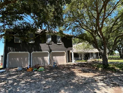 Close-up of exterior siding prep before painting on a Houston home