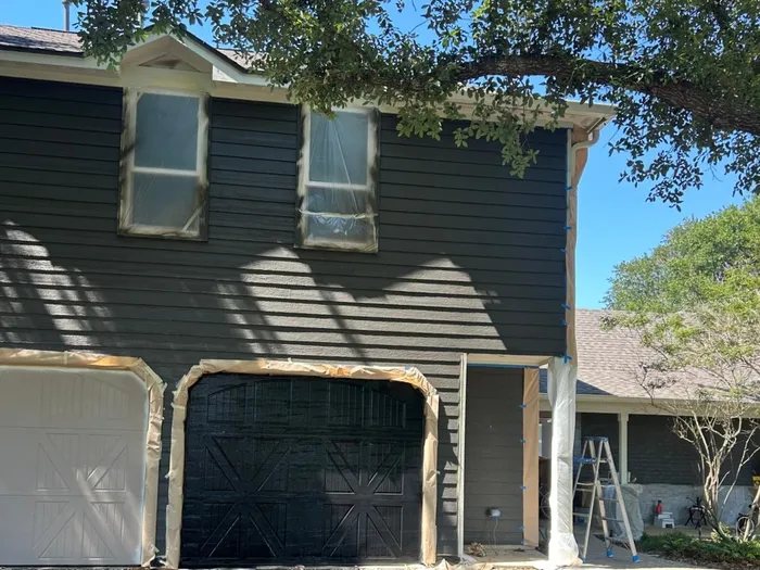Dark stained two-story house exterior repaint in Houston