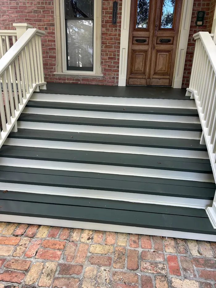 Freshly painted porch steps and brick entryway in Houston