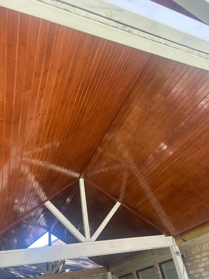 Finished stained wood ceiling of a covered patio addition