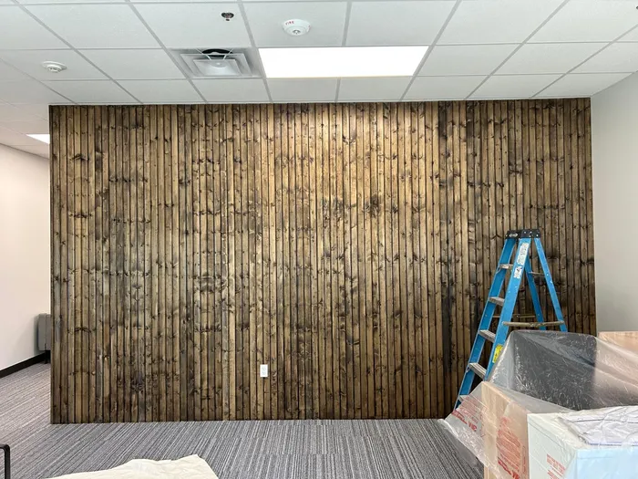 Stained wood accent wall installed in a commercial office space