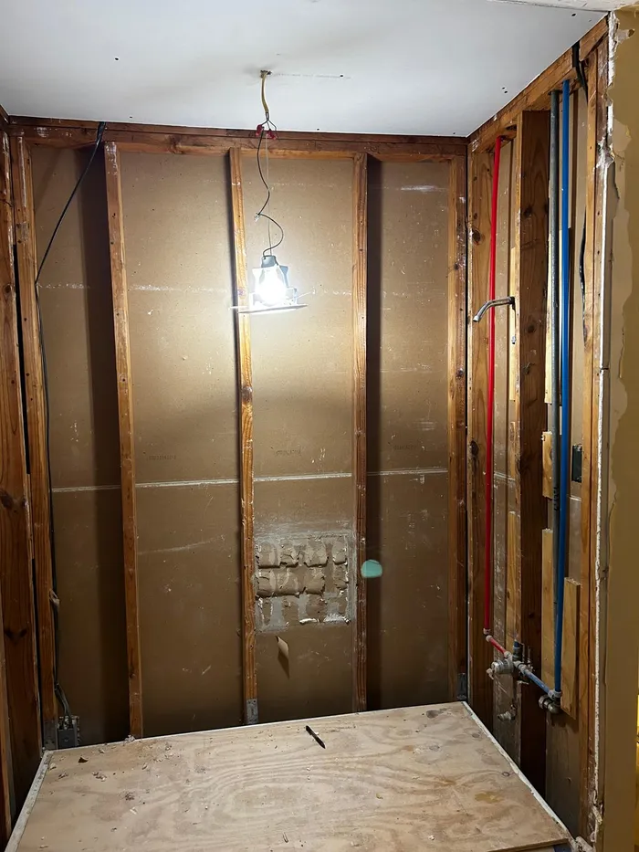Bathroom framing and plumbing rough-in before a remodel