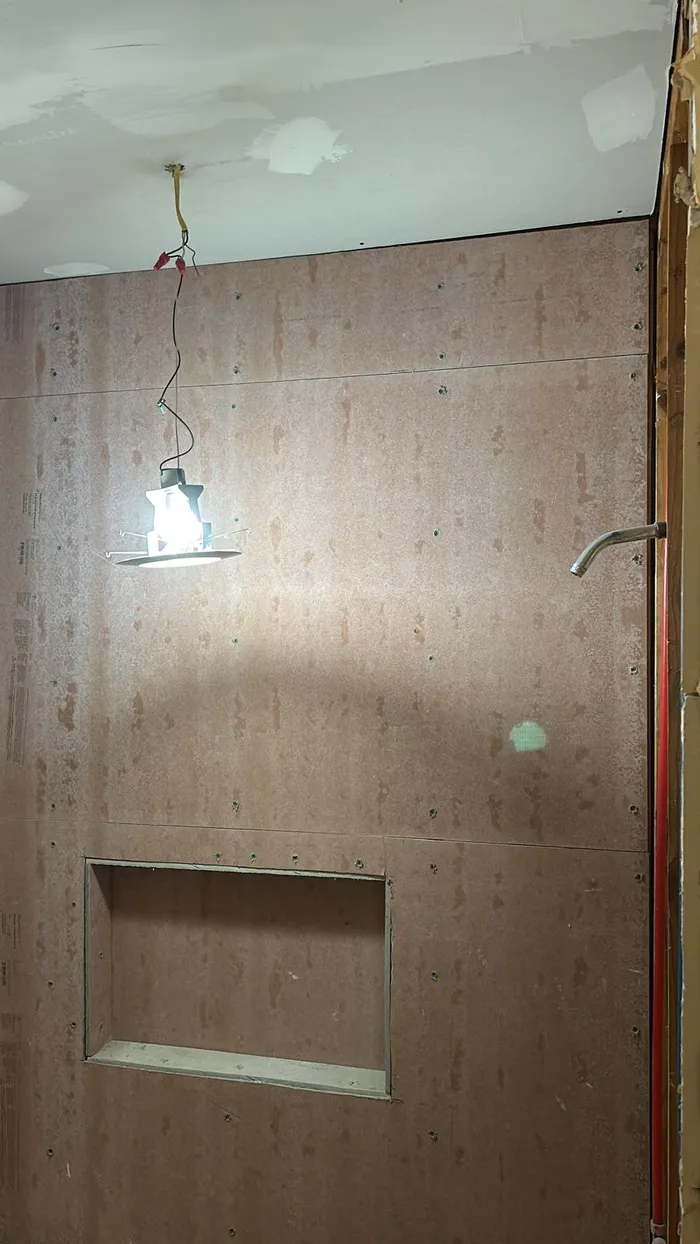 Bathroom shower niche framed with cement board mid-remodel