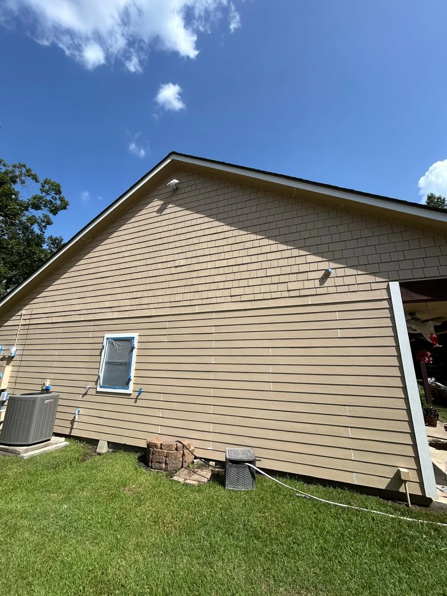 Same house exterior repainted in warm tan after the project
