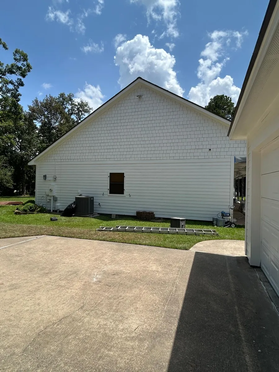 Unpainted white house exterior before repaint